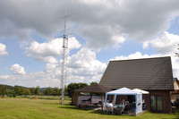 Antennentower neben Pavillon und Haus
