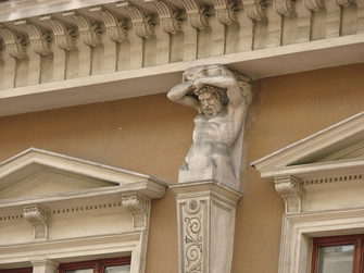 Many balconies and roofs are carried by "Atlas". According to the Greek mythology he lost the war against "Zeus" and was sentenced to carry the heaven on his shoulders, backs and necks henceforth.